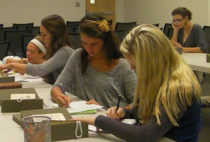 Students in FRE 301 studying various early editions of Beauty and the Beast