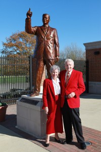 Dietzel with Anne in front of his Statue in the Cradle of Coaches Plaza