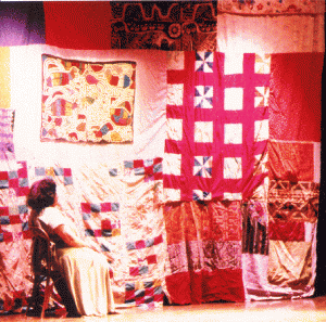 Lisa in front of the quilt that is the signature backdrop of Spiderwoman performances 