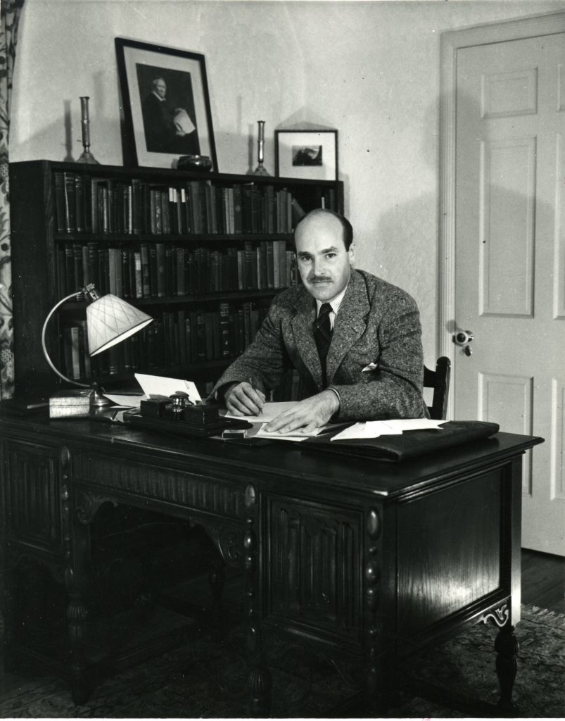 Photo of Walter Havighurst at his desk.