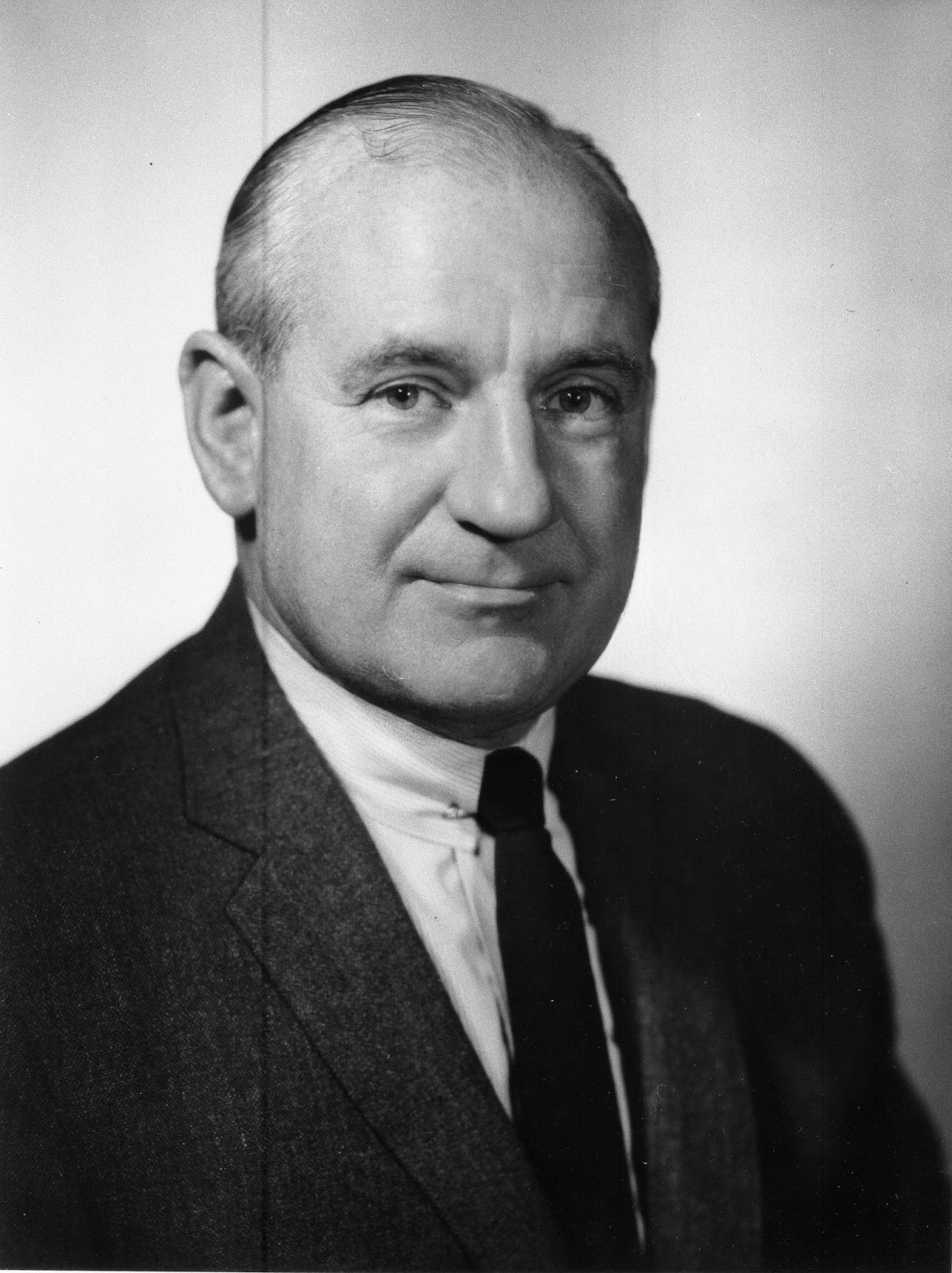 Headshot of Kenneth M. Grubb in a long tie and blazer